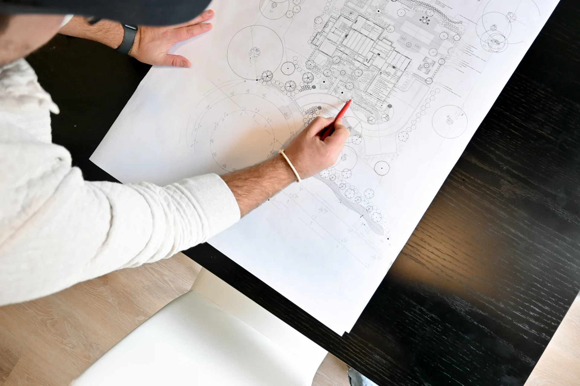 A designer refining a landscape plan by hand