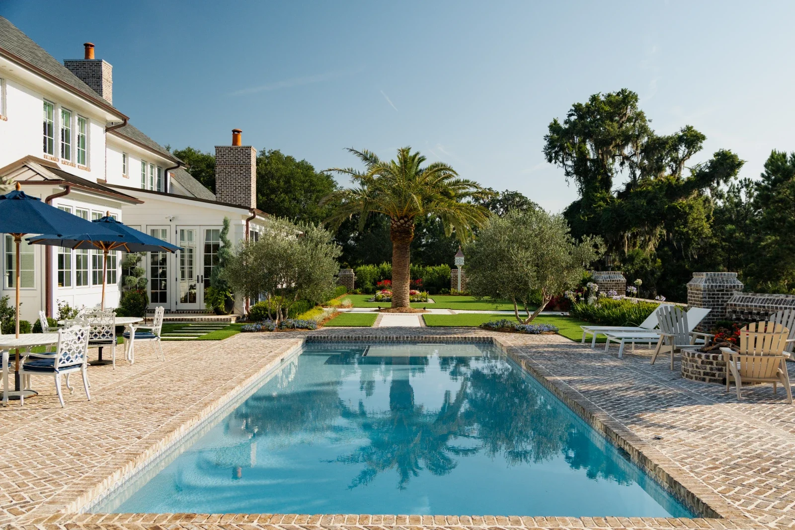 Swimming pool and stone terrace beside a coastal residence