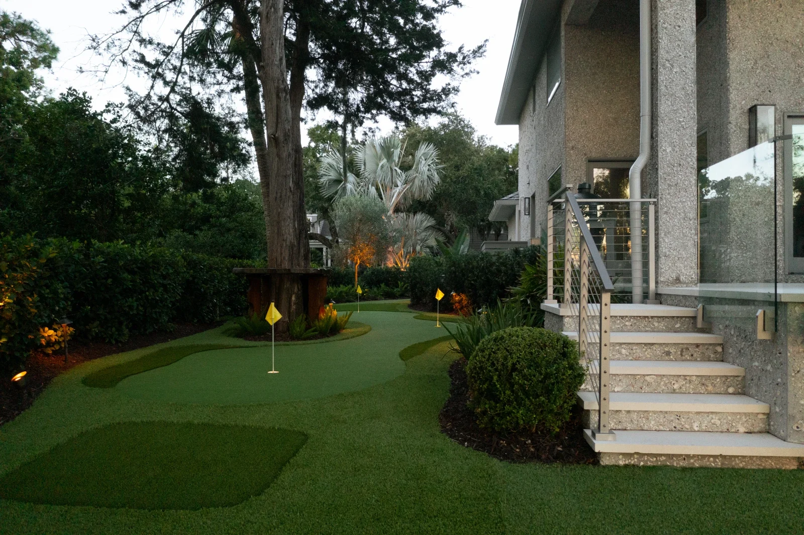 Backyard putting green alongside a landscaped coastal home